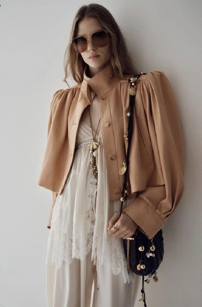 AI lookbook reference image with beige jacket, lace layers, sunglasses, and soft fashion editorial lighting