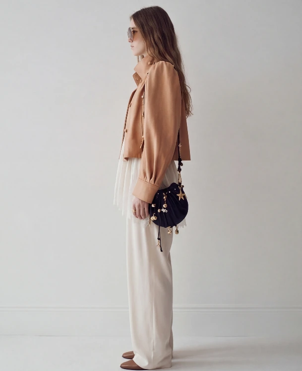 AI lookbook output showing a beige jacket outfit from the side profile